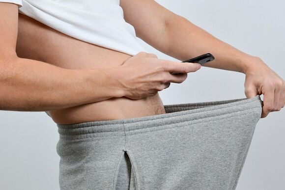 A man sees an enlarged penis down his pants