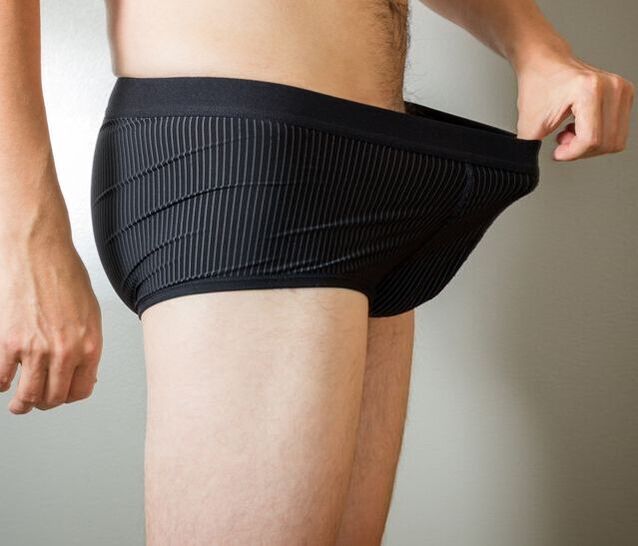 A man looks in his underpants after penis enlargement surgery